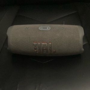 It’s a jbl charge 5 color grey medium size speaker got it for 128$